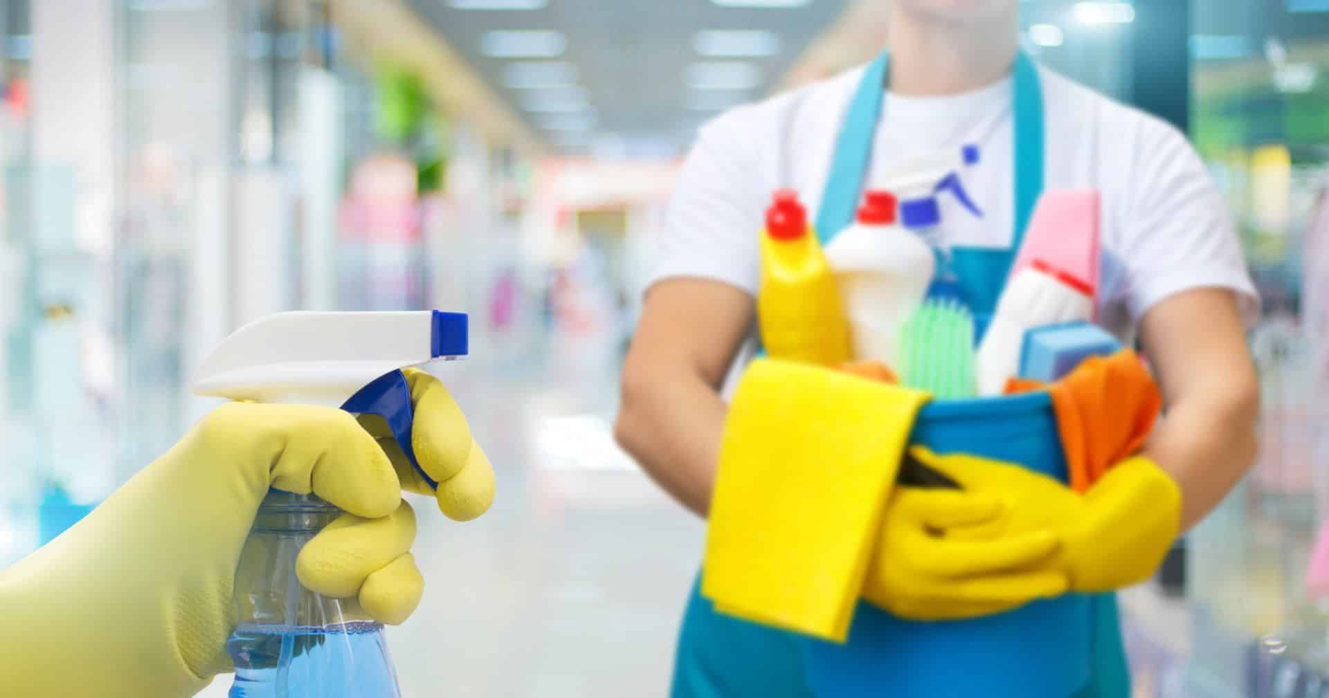 someone holding a bucket of cleaning tools and supplies