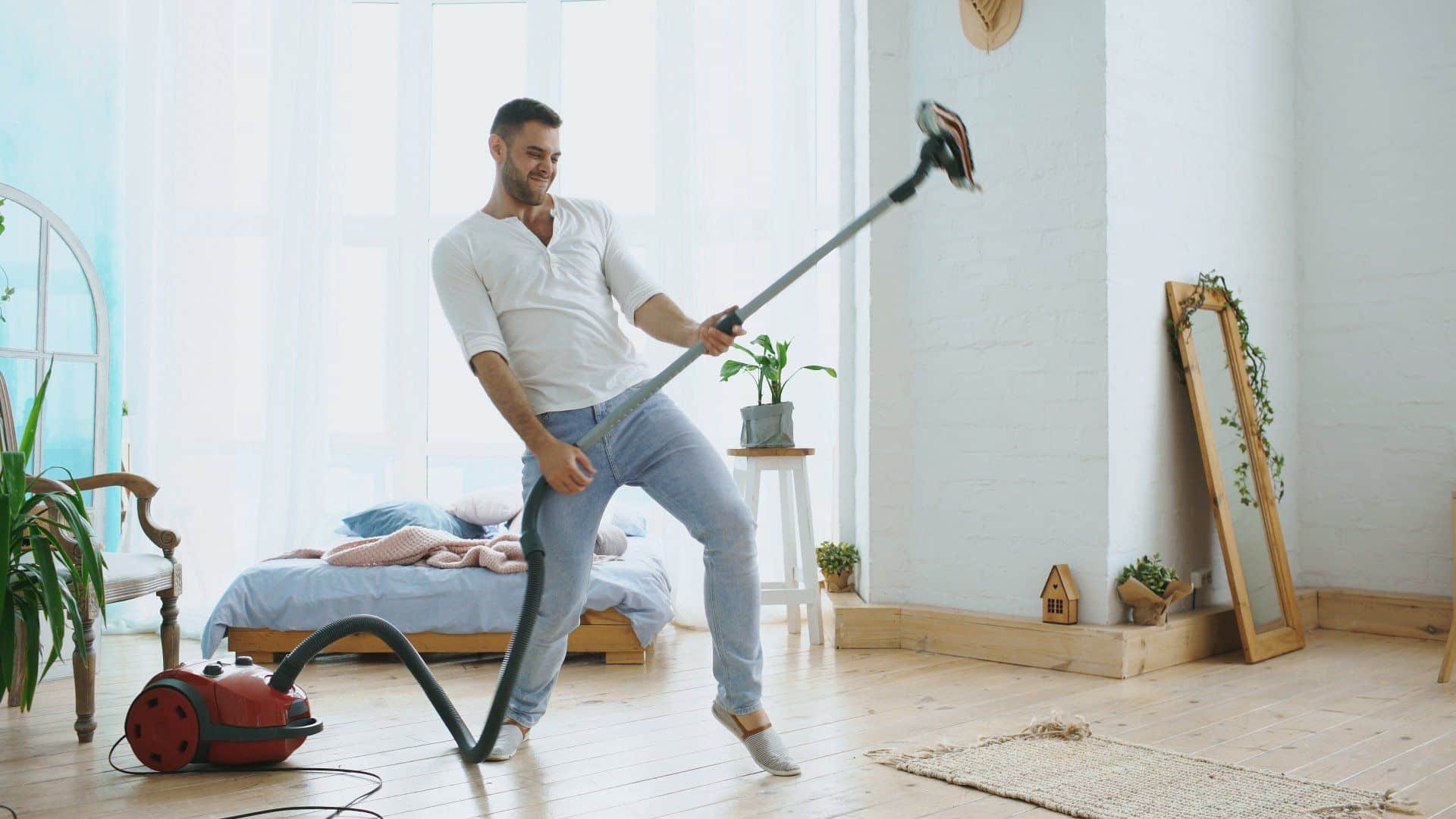 a man playing air guitar on a traditional vacuum