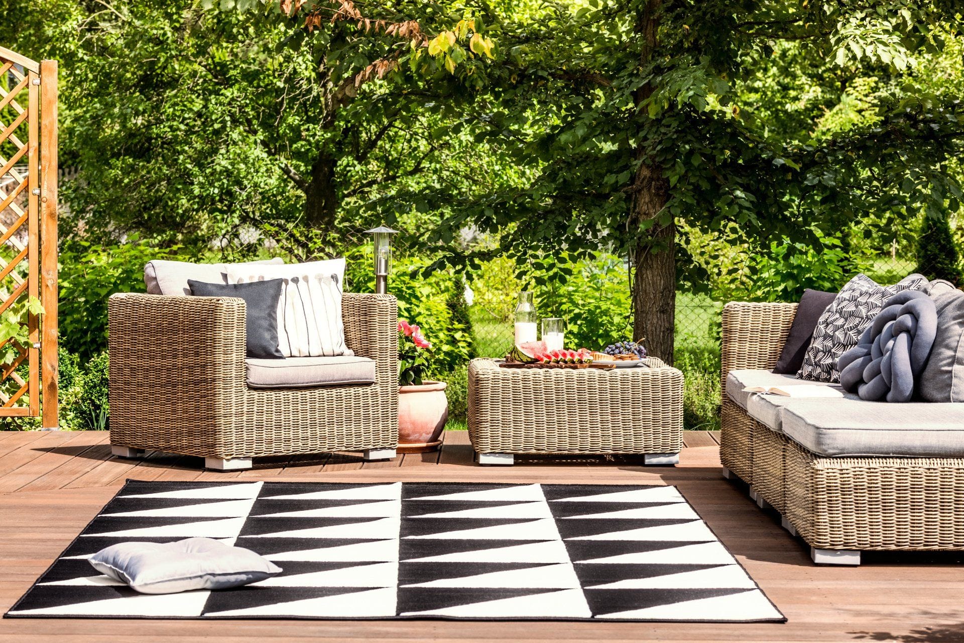 an outdoor seating area with a black and white geometric rug design