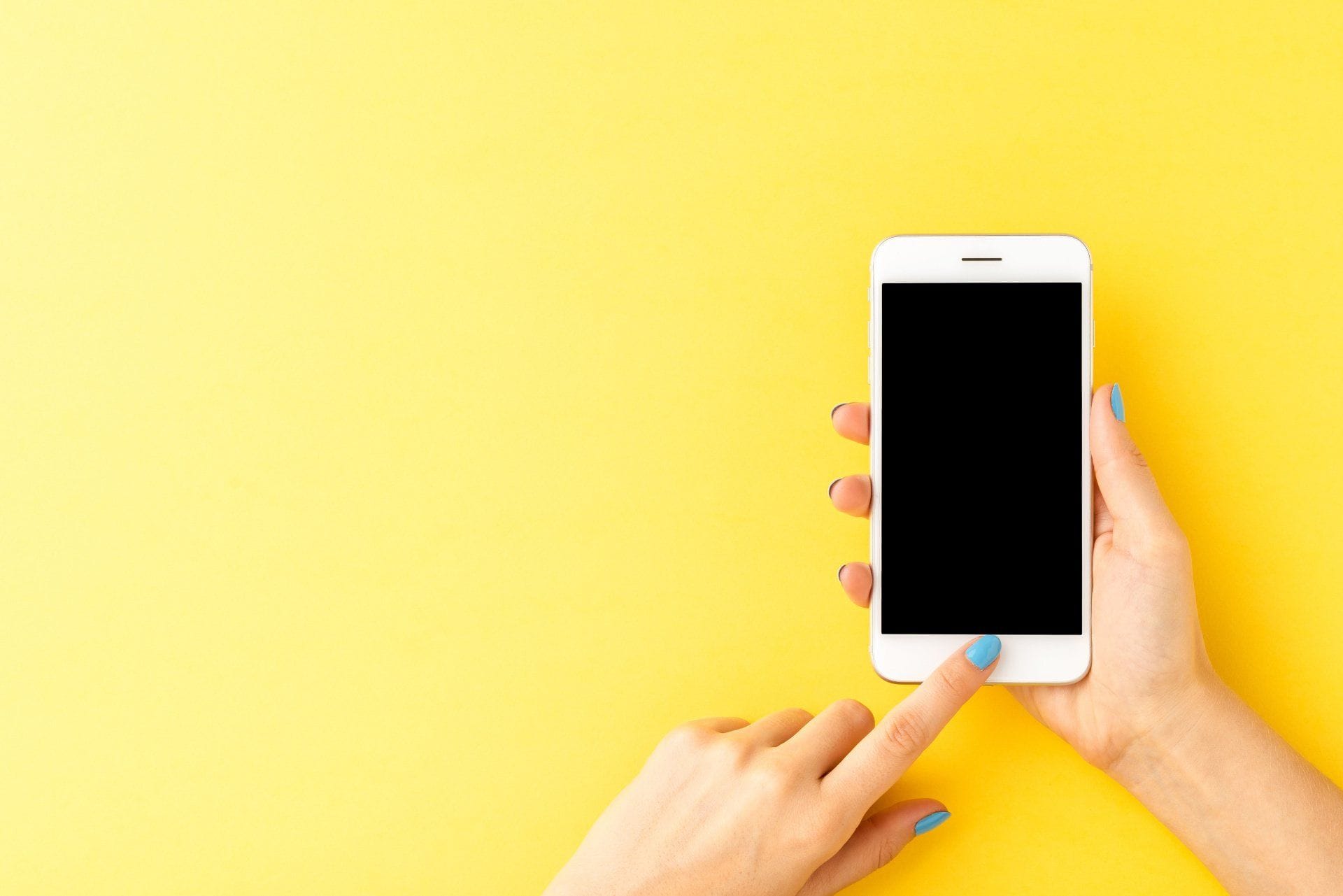 9 Things You Can Clean While Working Remotely 7 someone using an iphone on a yellow background