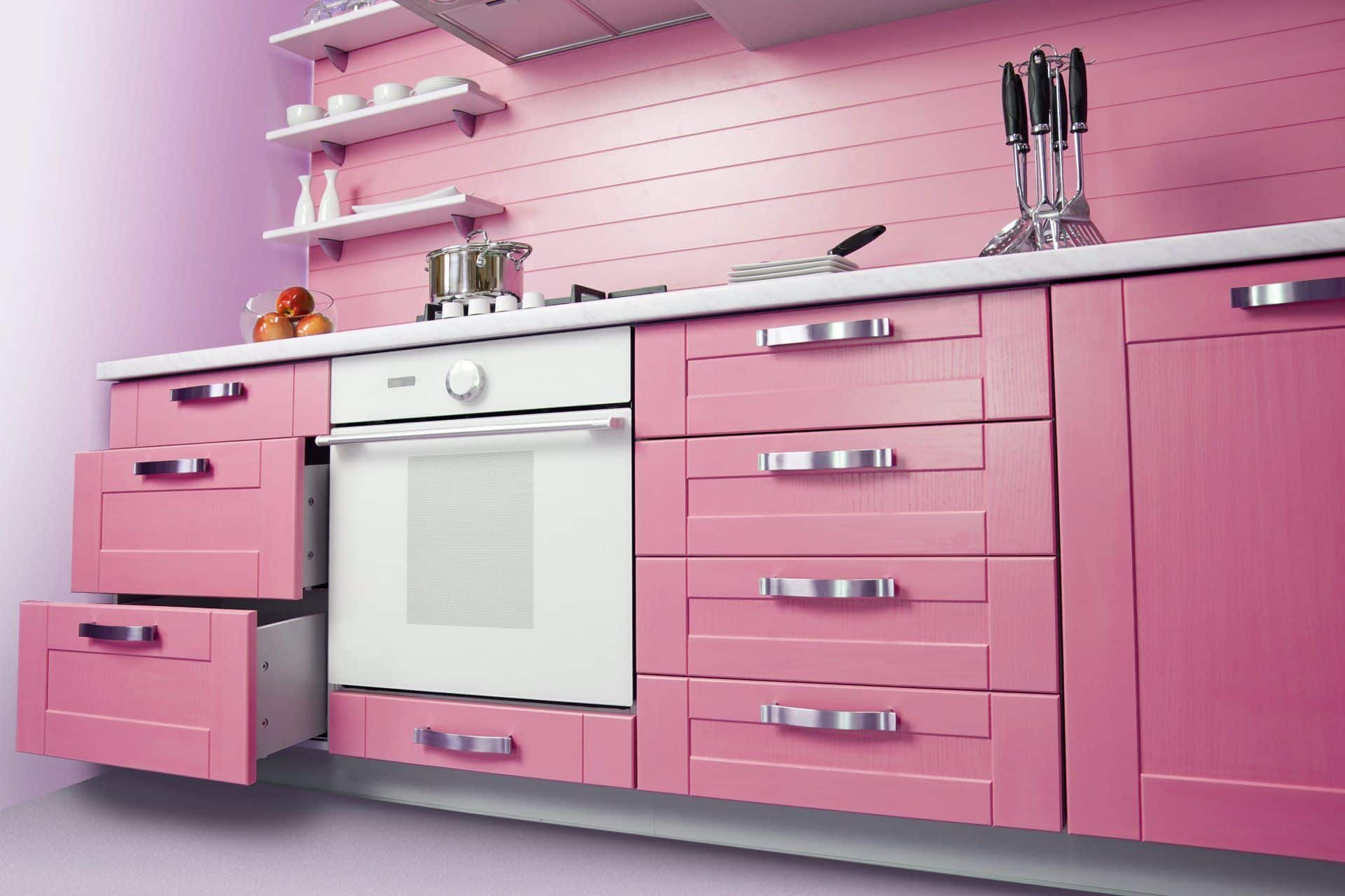 a kitchen with pink cabinets