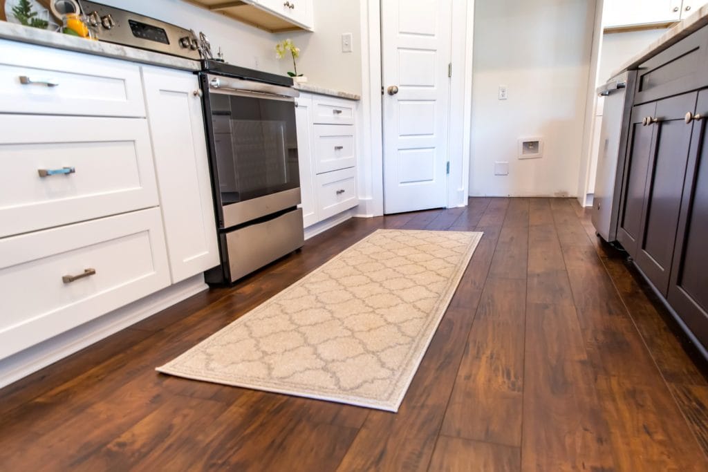 A small area rug place in a high-traffic area of the kitchen to protect from wear and tear on hardwood floors.
