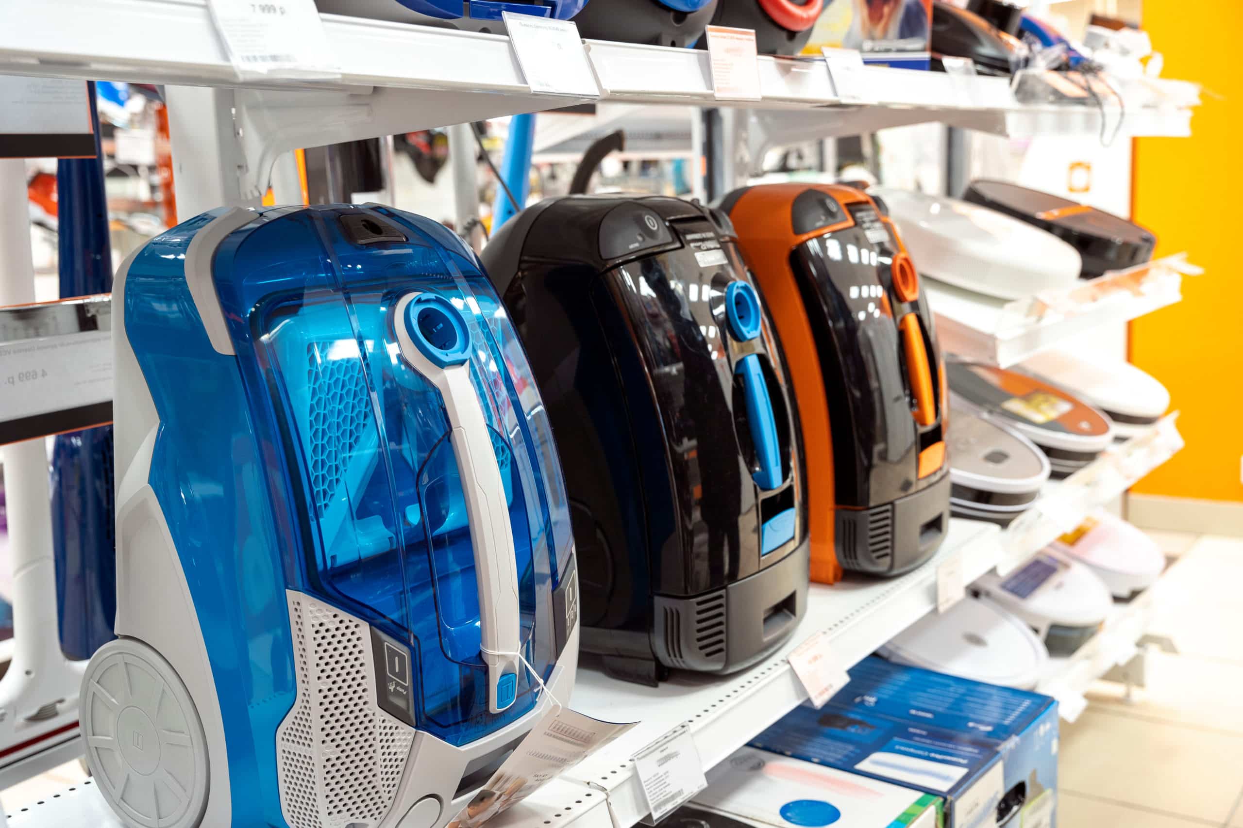 sale of vacuum cleaners in a home appliance store, household vacuum cleaners on a supermarket shelf