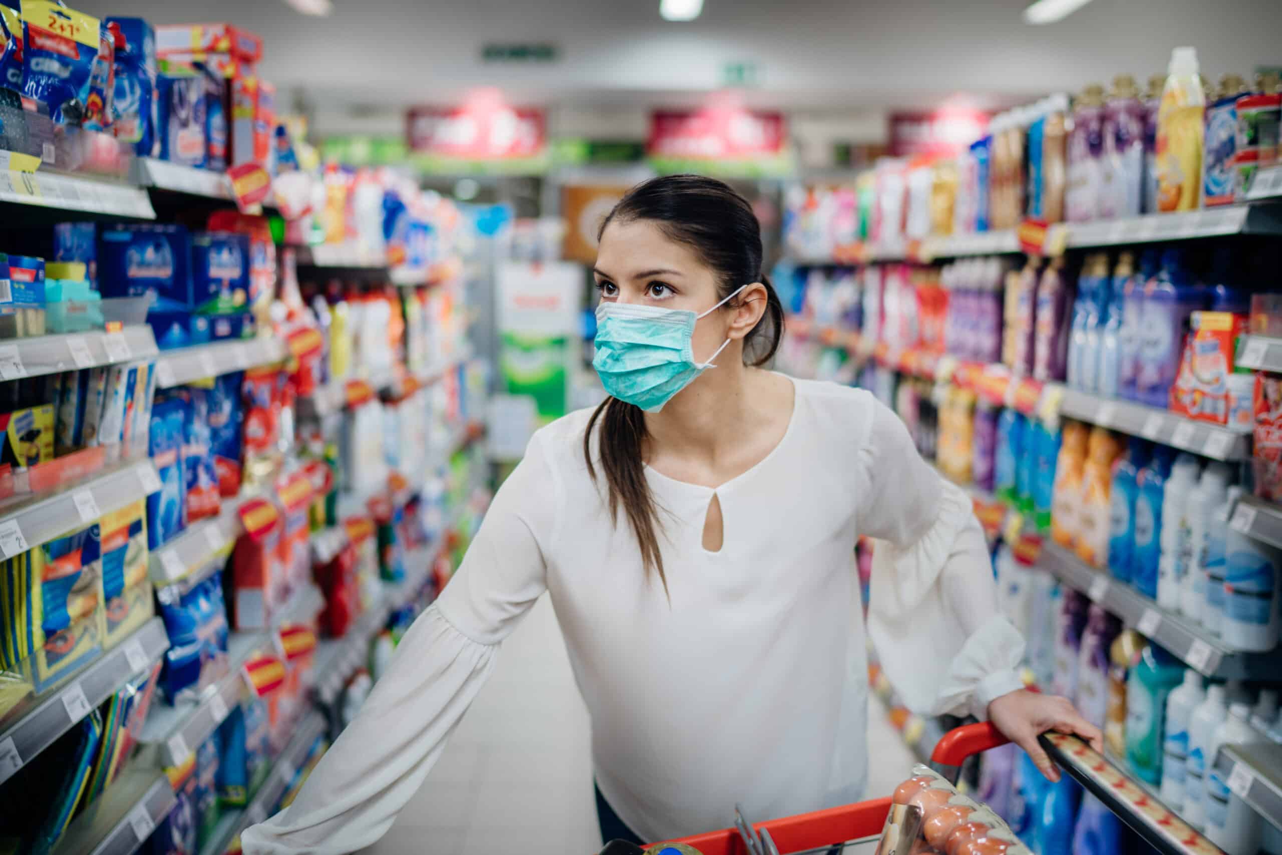 4 Products That Do the Hard Cleaning for You 2 Woman wearing protective mask preparing for virus pandemic spread quarantine.Finding the right products on the shelves in the supermarket.Hygiene, cleaning and disinfection products.Budget buying.
